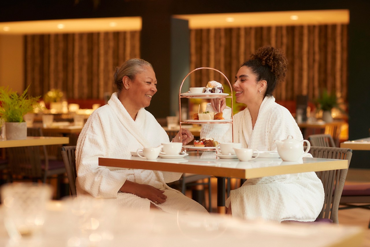 A mum and daughter in the sauna.